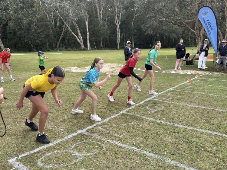 four students at the start of a running race