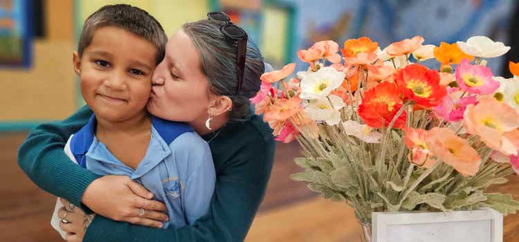 A mother kissing the cheek of her child on Mother's Day