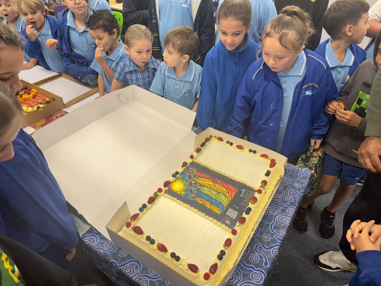 students looking at the NAIDOC celebration cake