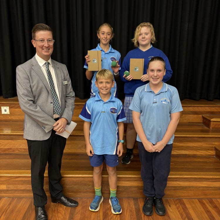 Four public speaking students getting an award with Maclean High School Principal