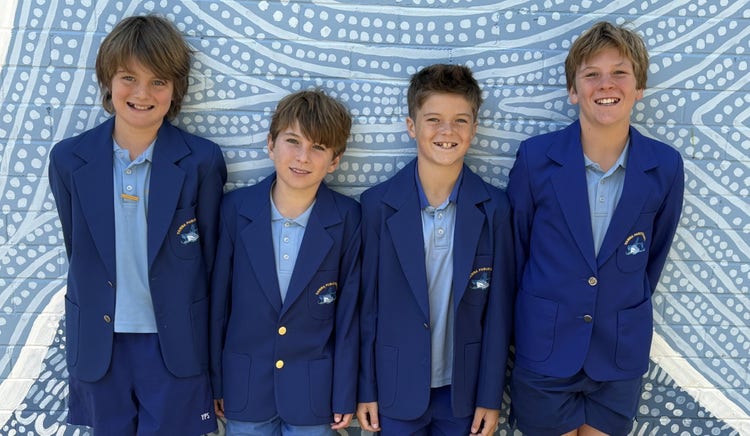 four students in blazers from the debating team