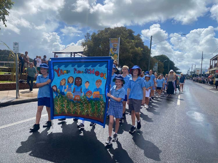 Students marching with banner at the Cane Harvest Festival