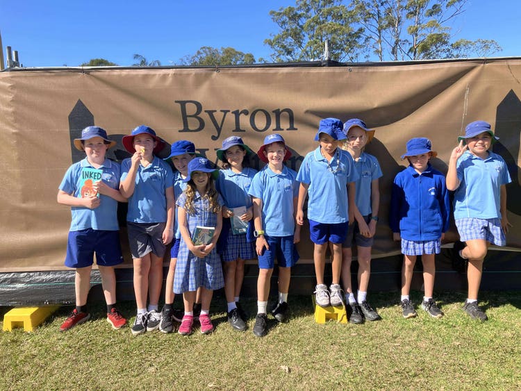 Photo fo students in front of the Byron Writers Festival sign